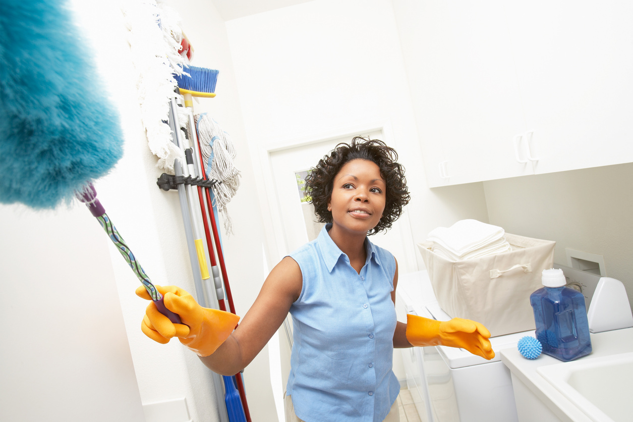 Woman dusting at home