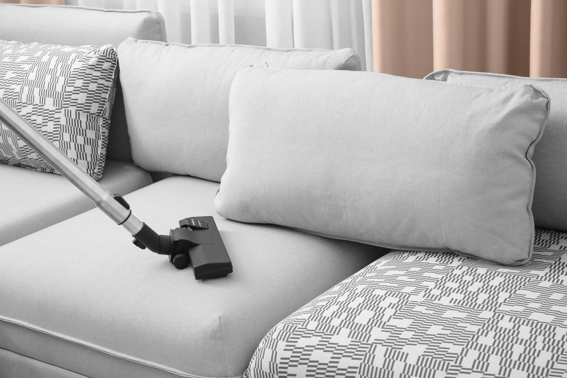 Cleaning Couch with a Vacuum Cleaner at Home